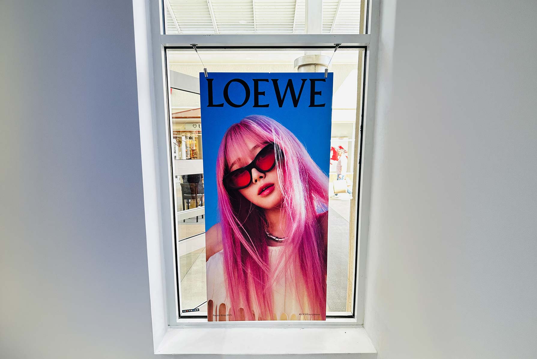 Loewe eyewear poster hanging in a store window