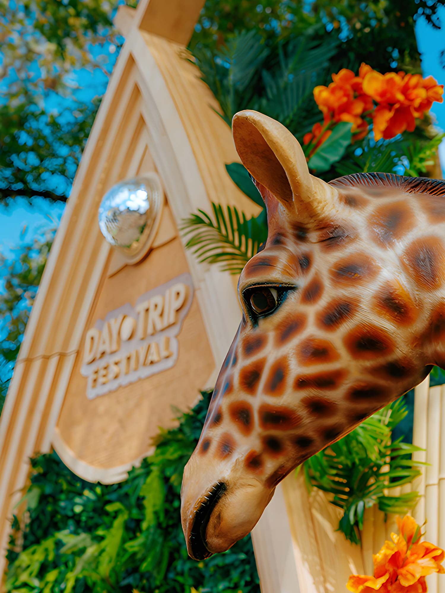 Day Trip Festival sign with a giraffe sculpture